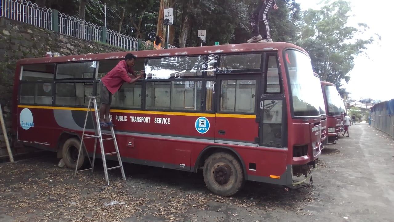 A picture containing outdoor, bus, tree, transport Description automatically generated
